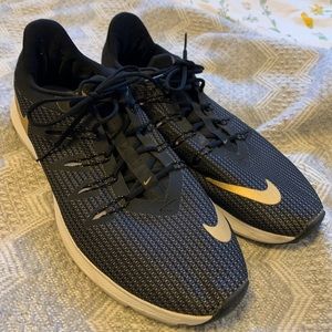 Black Nike running shoes with a gold logo